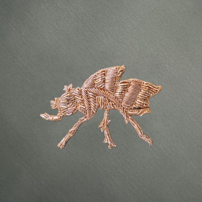 Embroidered sage green velvet insect cushion cover