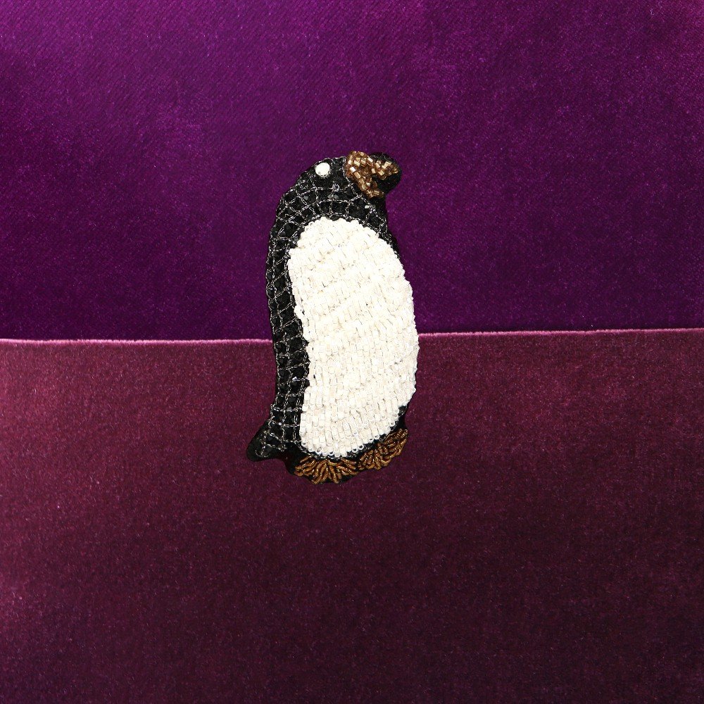 Embroidered bi-colored burgundy velvet penguin cushion