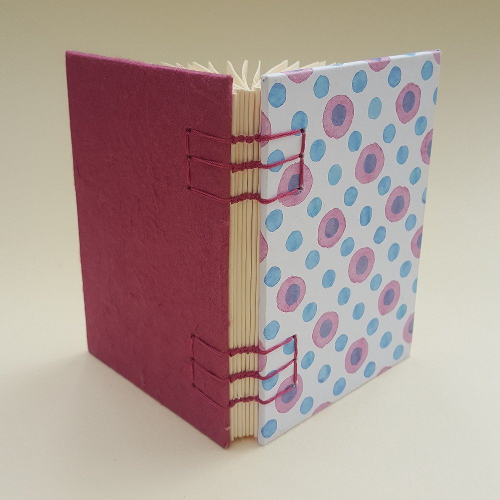 Small journal: magenta 
evil eye pattern