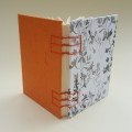 Small journal: orange and black cherry blossom pattern