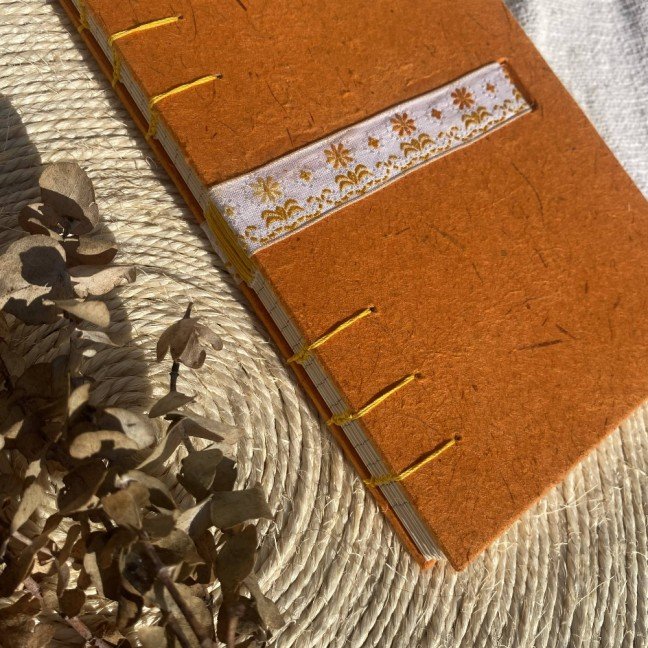 Journal: orange with 
embroidered ribbon