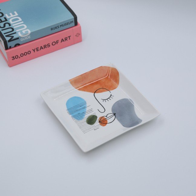 Two Porcelain Ashtrays: 
Abstract Faces Design